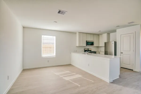 a kitchen with stainless steel appliances a refrigerator sink and microwave