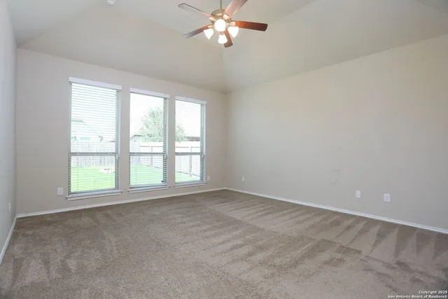 a view of a livingroom with a ceiling fan and window