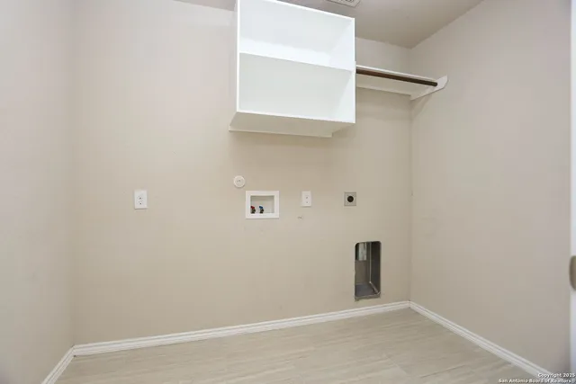 a view of a small space with wooden floor and a window