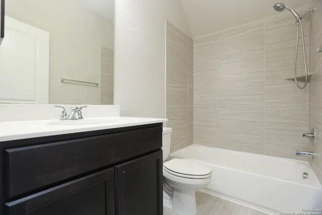 a bathroom with a sink a toilet and bathtub