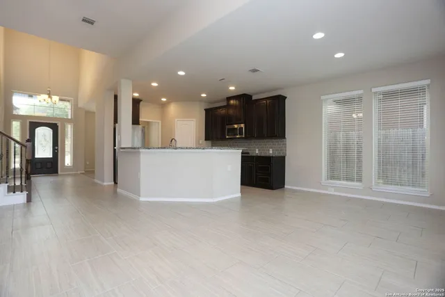 a view of a kitchen with a sink and a refrigerator