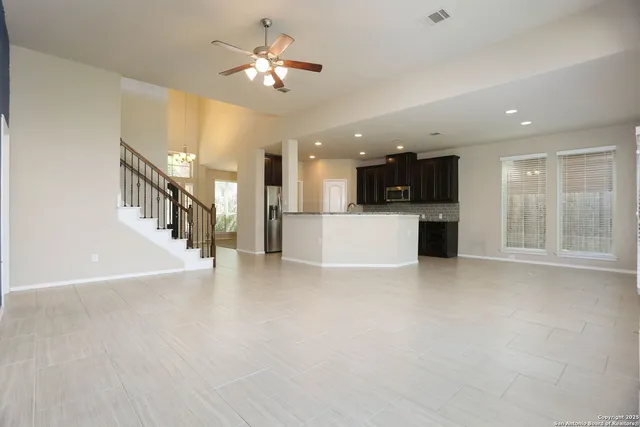 a view of a kitchen with a sink and a refrigerator