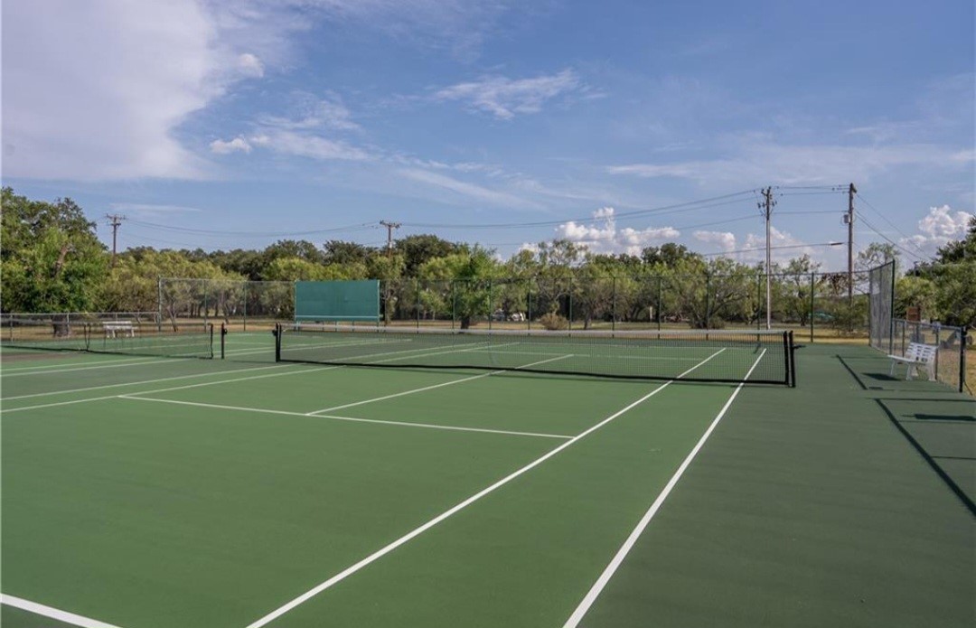 1033 Coventry Road Spicewood, TX 78669 - Photo 11 of 13 a view of an outdoor space and tennis court