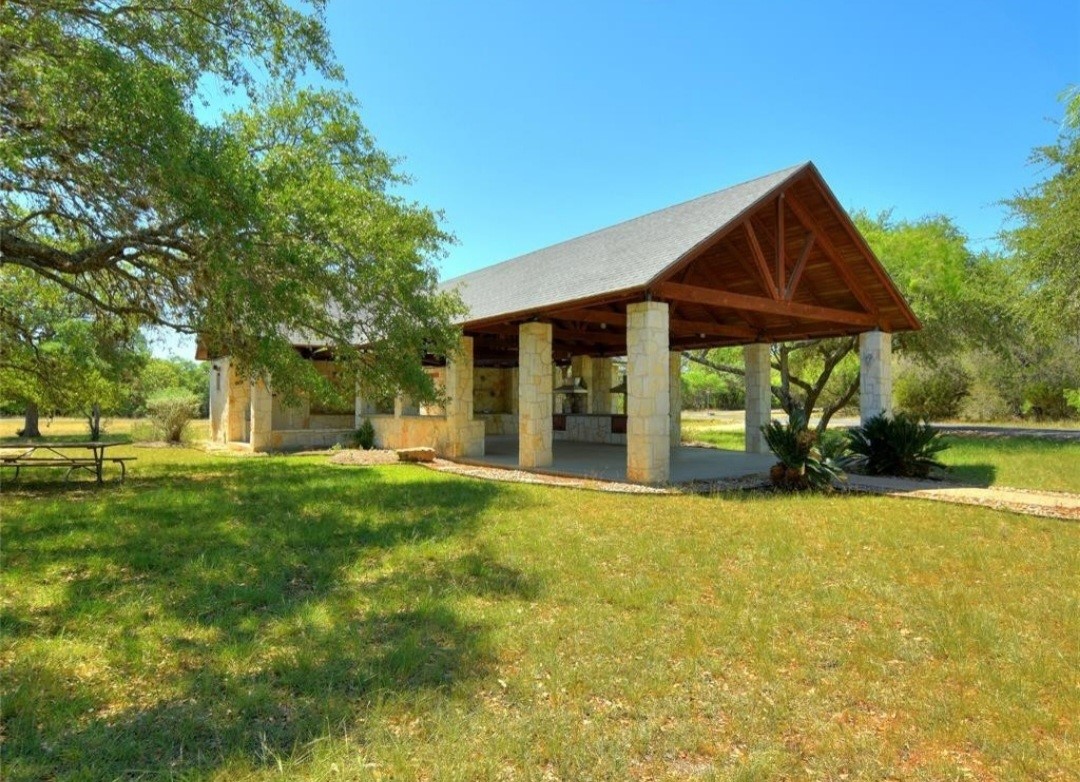 1033 Coventry Road Spicewood, TX 78669 - Photo 10 of 13 a view of a house with backyard and a tree