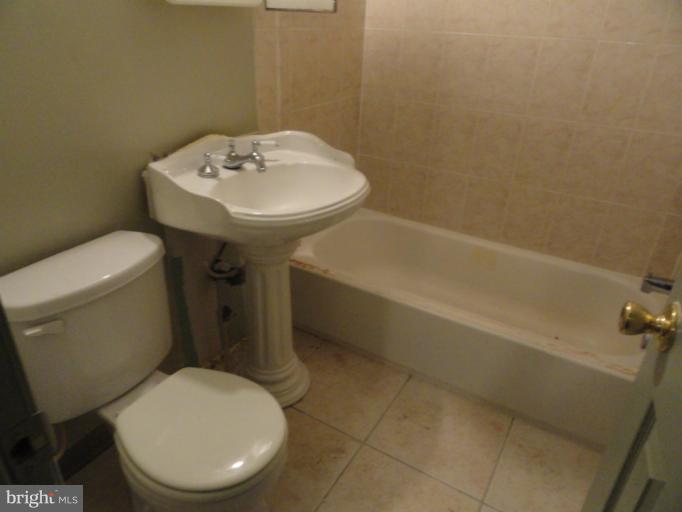 a white toilet sitting next to a bathroom sink