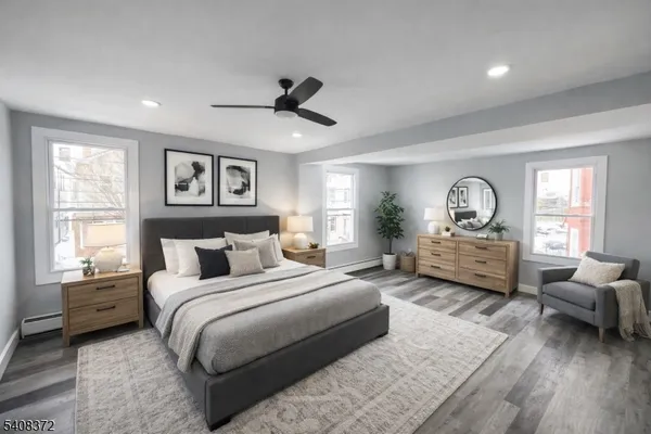 a bedroom with a bed large window and couch