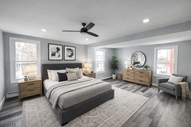 a bedroom with a bed large window and couch