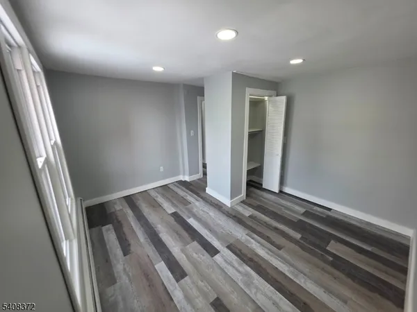 a view of a room with wooden floor