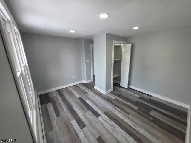 a view of a room with wooden floor