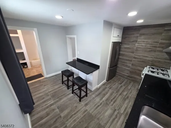 a view of a hallway with wooden floor and stairs