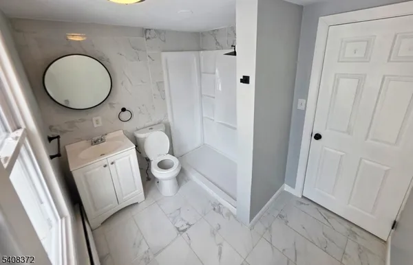 a bathroom with a toilet sink and a mirror