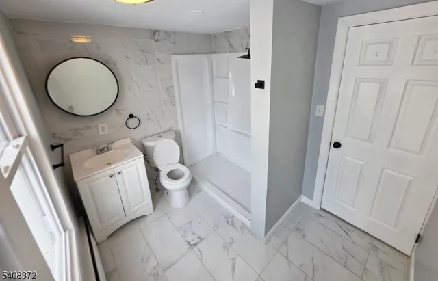 a bathroom with a toilet sink and a mirror