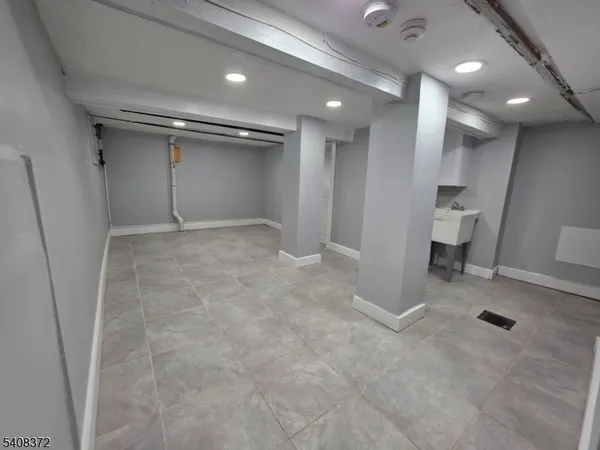 an empty room and a bathroom