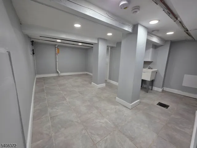 an empty room and a bathroom