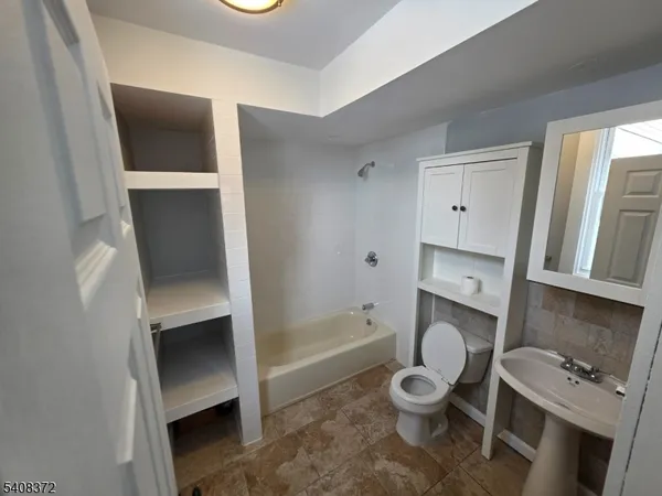 a bathroom with a toilet a sink and bathtub
