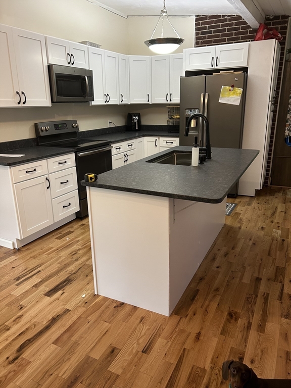 88 Hiland Road Charlton, MA 01507 - Photo 2 of 11 a kitchen with granite countertop a sink a stove and cabinets