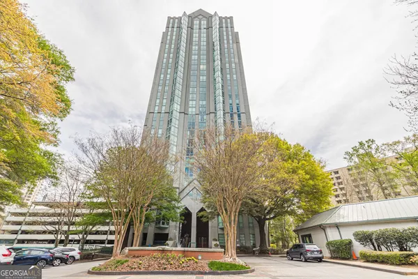 a view of a tall building next to a road