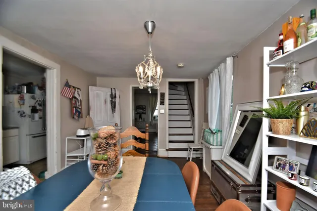 a living room with furniture a rug and a chandelier