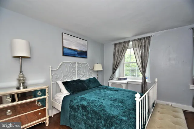 a view of a livingroom with furniture window wooden floor and front door