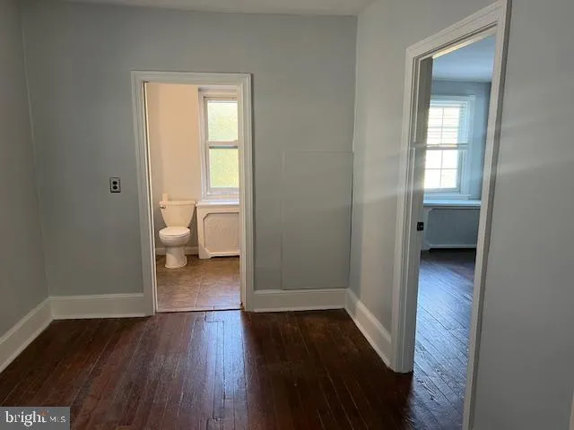 a bedroom with a bed and a television