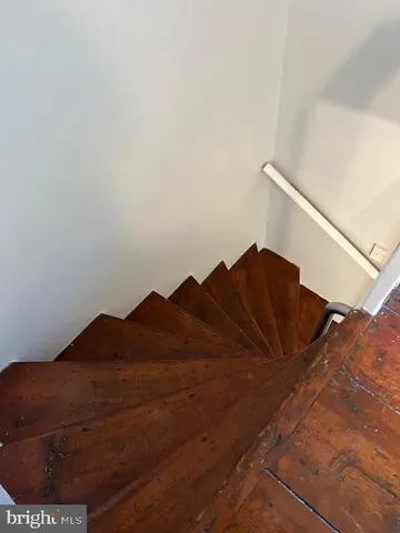 a living room with furniture a window and wooden floor