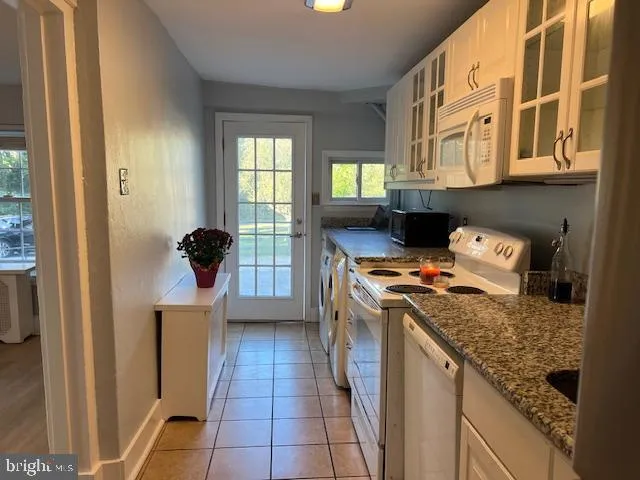 a kitchen with a stove a sink and a refrigerator