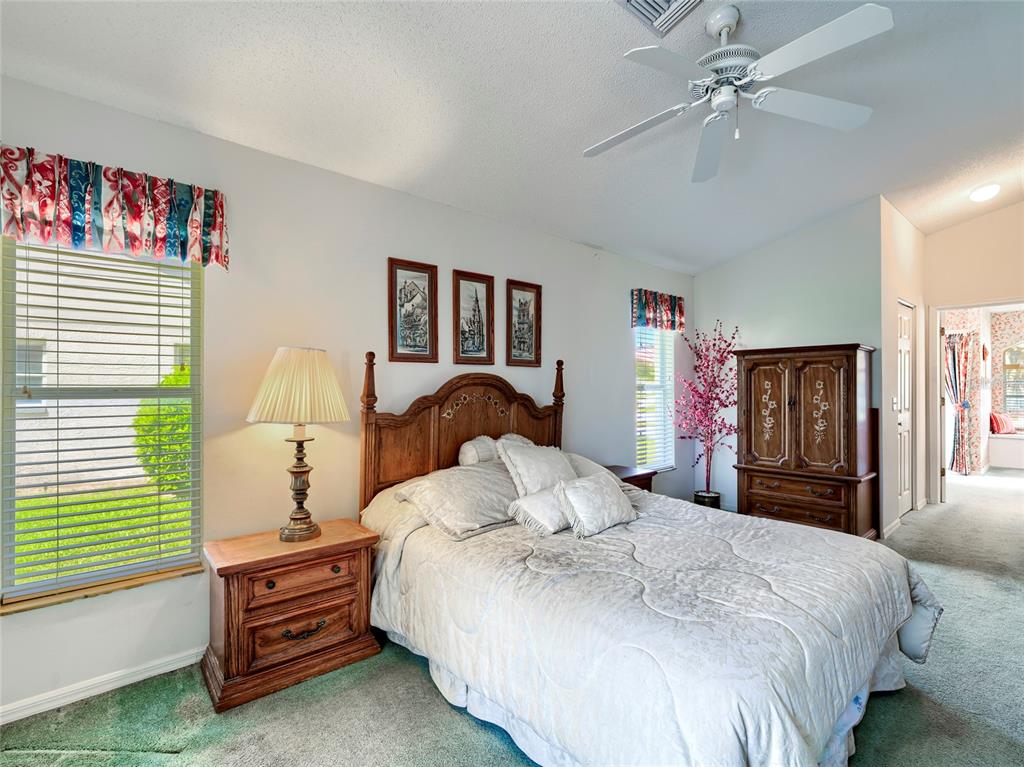 11228 Windrush Circle Hudson, FL 34667 - Photo 30 of 67 a bedroom with a bed and a chandelier