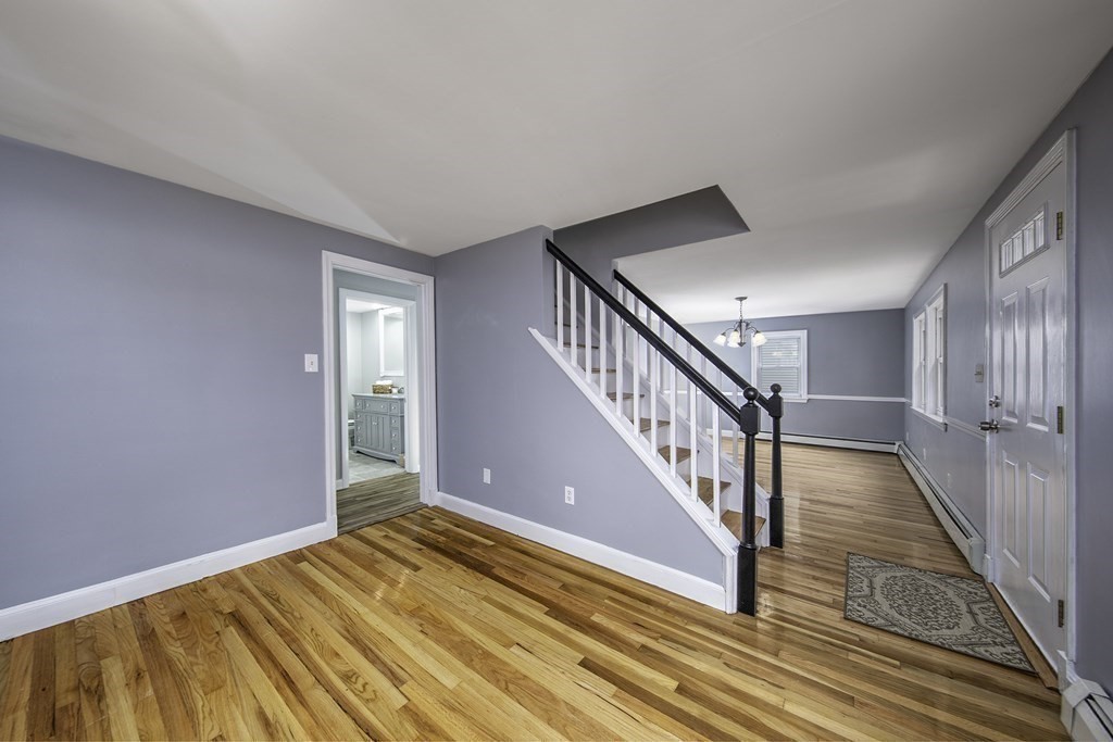 40 Brookside Avenue Danvers, MA 01923 - Photo 11 of 27 a view of an empty room with wooden floor and stairs
