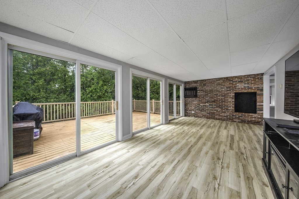 40 Brookside Avenue Danvers, MA 01923 - Photo 13 of 27 a view of empty room with wooden floor and fireplace