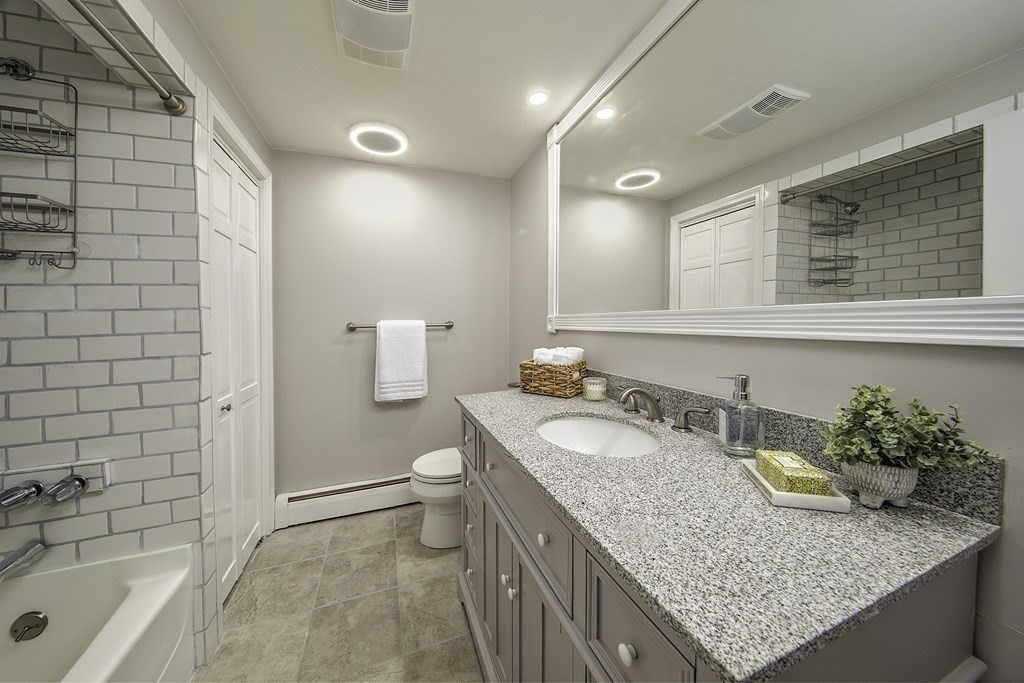 40 Brookside Avenue Danvers, MA 01923 - Photo 17 of 27 a bathroom with a granite countertop sink a toilet and bathtub