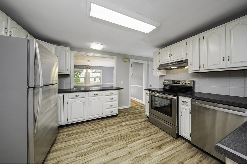 40 Brookside Avenue Danvers, MA 01923 - Photo 4 of 27 a kitchen with white cabinets stainless steel appliances and sink