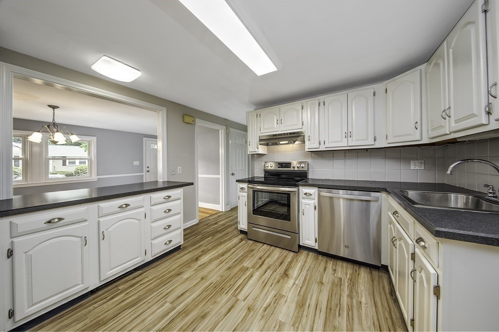 40 Brookside Avenue Danvers, MA 01923 - Photo 5 of 27 a kitchen with granite countertop white cabinets and white appliances