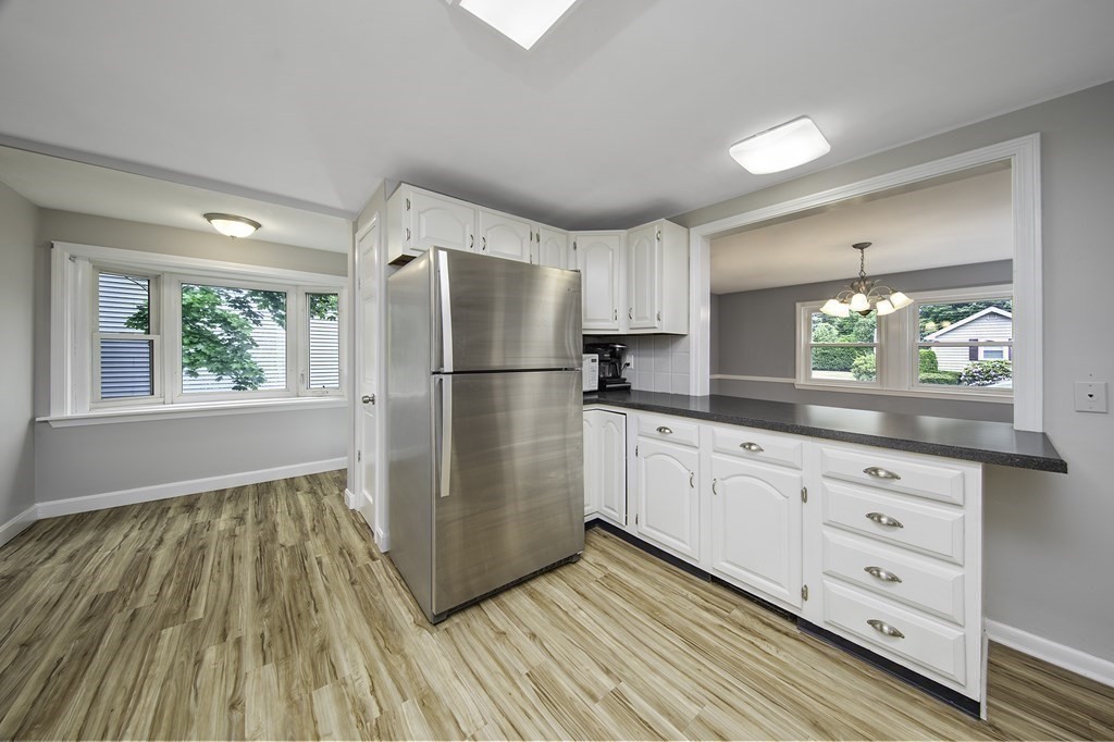 40 Brookside Avenue Danvers, MA 01923 - Photo 7 of 27 a kitchen with granite countertop white cabinets and stainless steel appliances