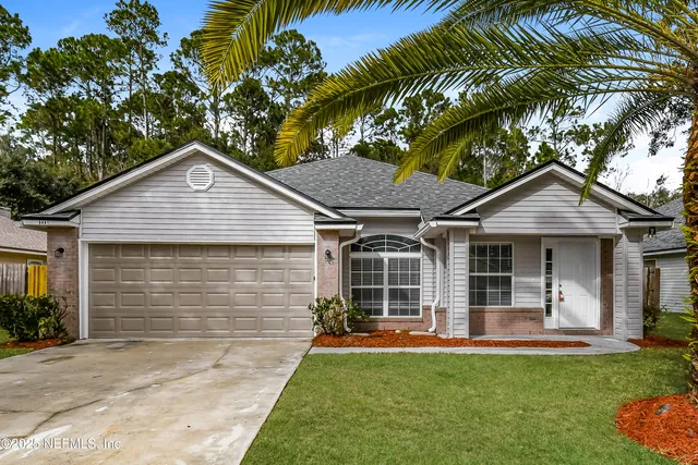 a front view of a house with a garden and patio