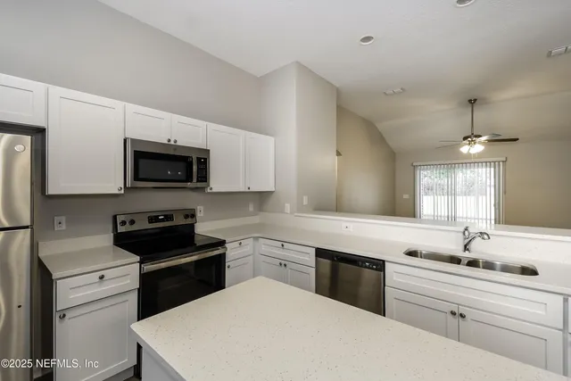 a kitchen with a sink stove and microwave