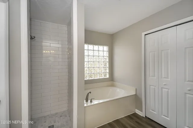 a bathroom with a bathtub and shower