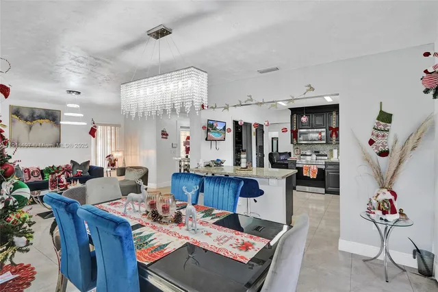 a kitchen with stainless steel appliances granite countertop a refrigerator and a stove