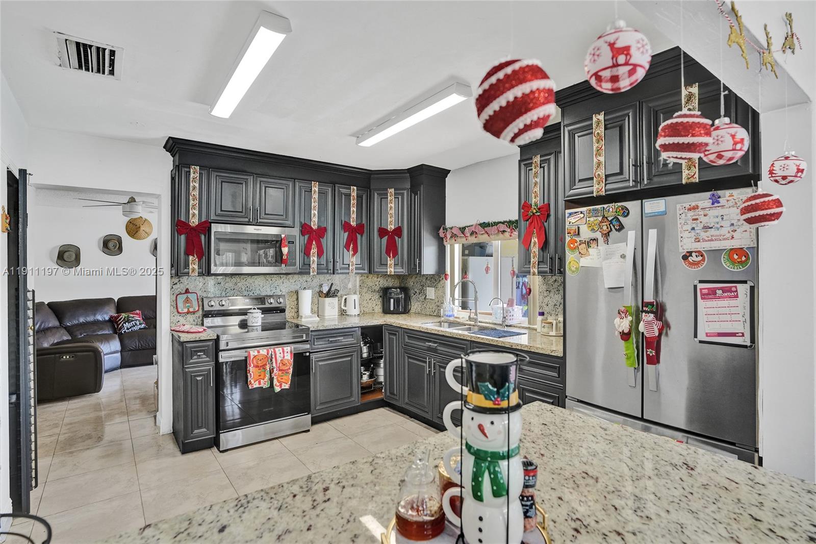 2 Northeast 160th Street Miami, FL 33162 - Photo 13 of 54 a kitchen with stainless steel appliances granite countertop a sink stove and refrigerator