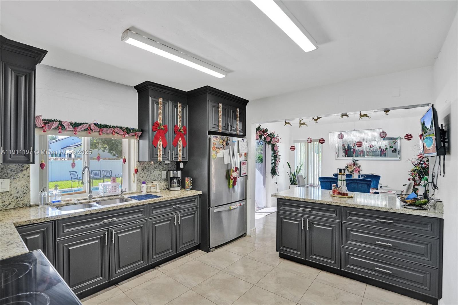 2 Northeast 160th Street Miami, FL 33162 - Photo 14 of 54 a kitchen with sink cabinets and window