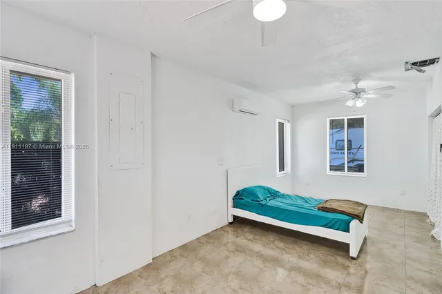 a living room with a bed furniture and windows