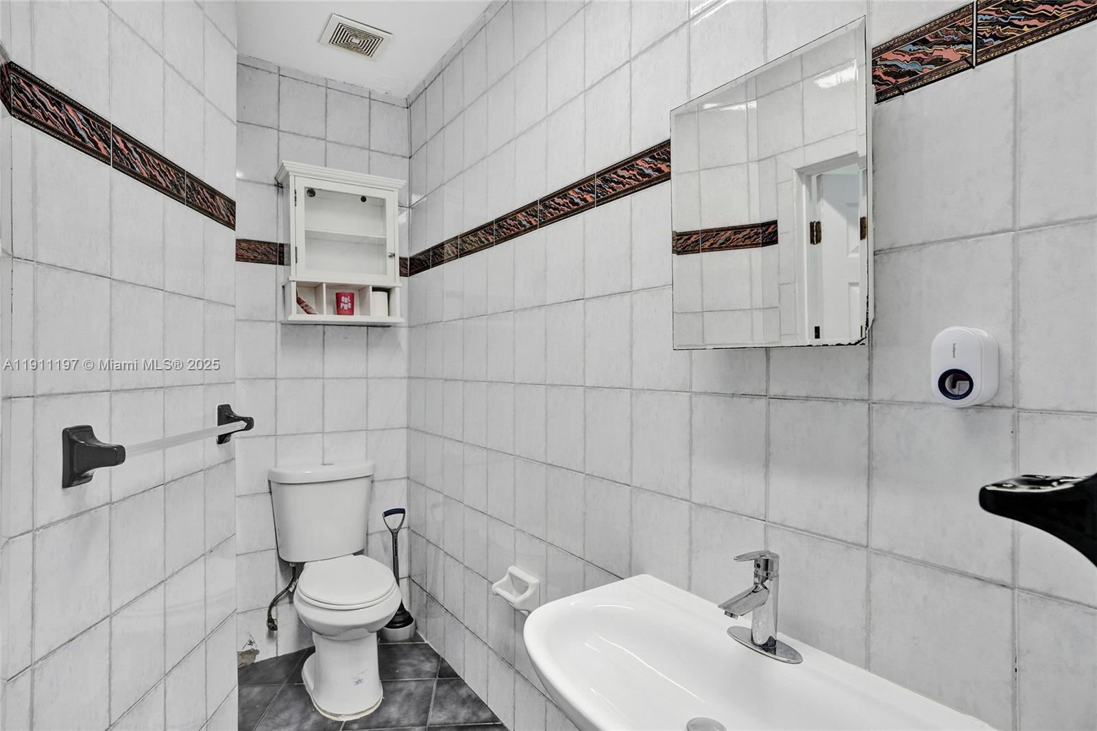 2 Northeast 160th Street Miami, FL 33162 - Photo 27 of 54 a bathroom with a toilet sink and shower