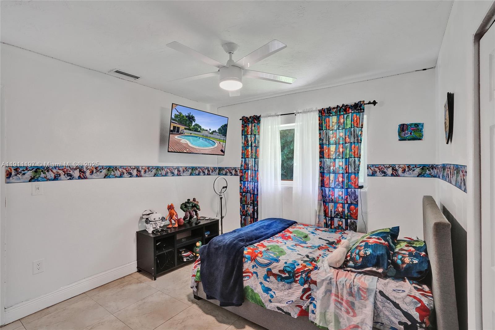 2 Northeast 160th Street Miami, FL 33162 - Photo 31 of 54 a bedroom with furniture and a book shelf