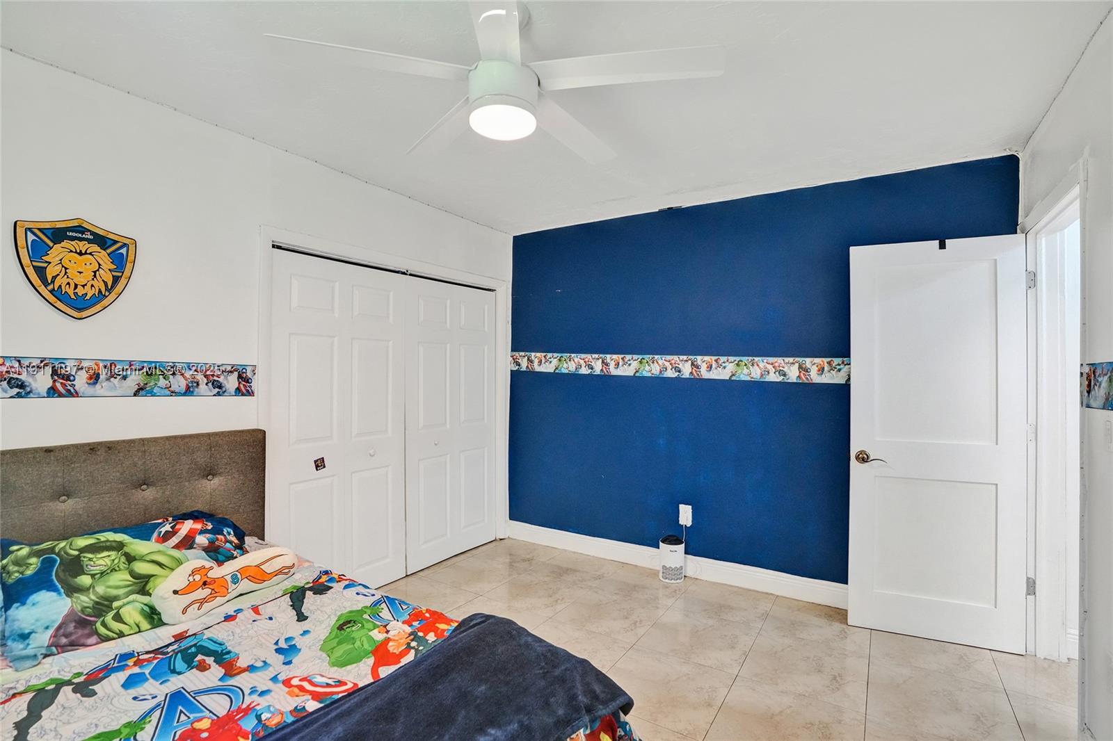 2 Northeast 160th Street Miami, FL 33162 - Photo 32 of 54 a bedroom with a bed and a baby bed