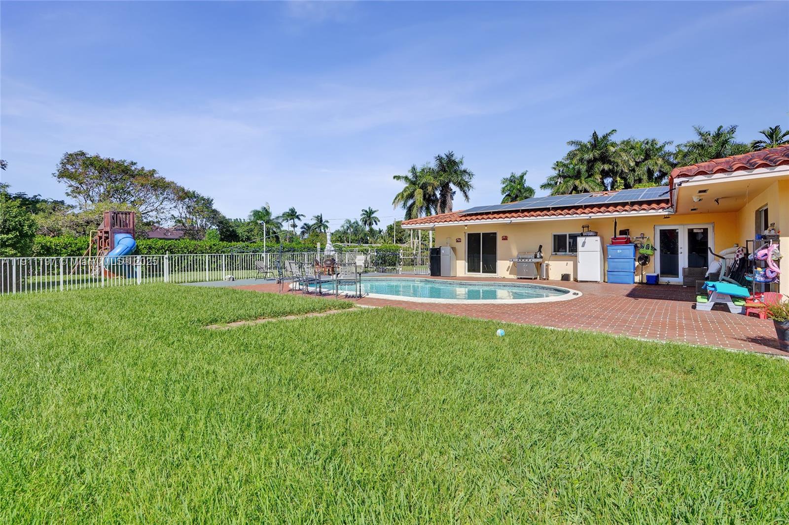 2 Northeast 160th Street Miami, FL 33162 - Photo 39 of 54 a front view of a house with a yard table and chairs