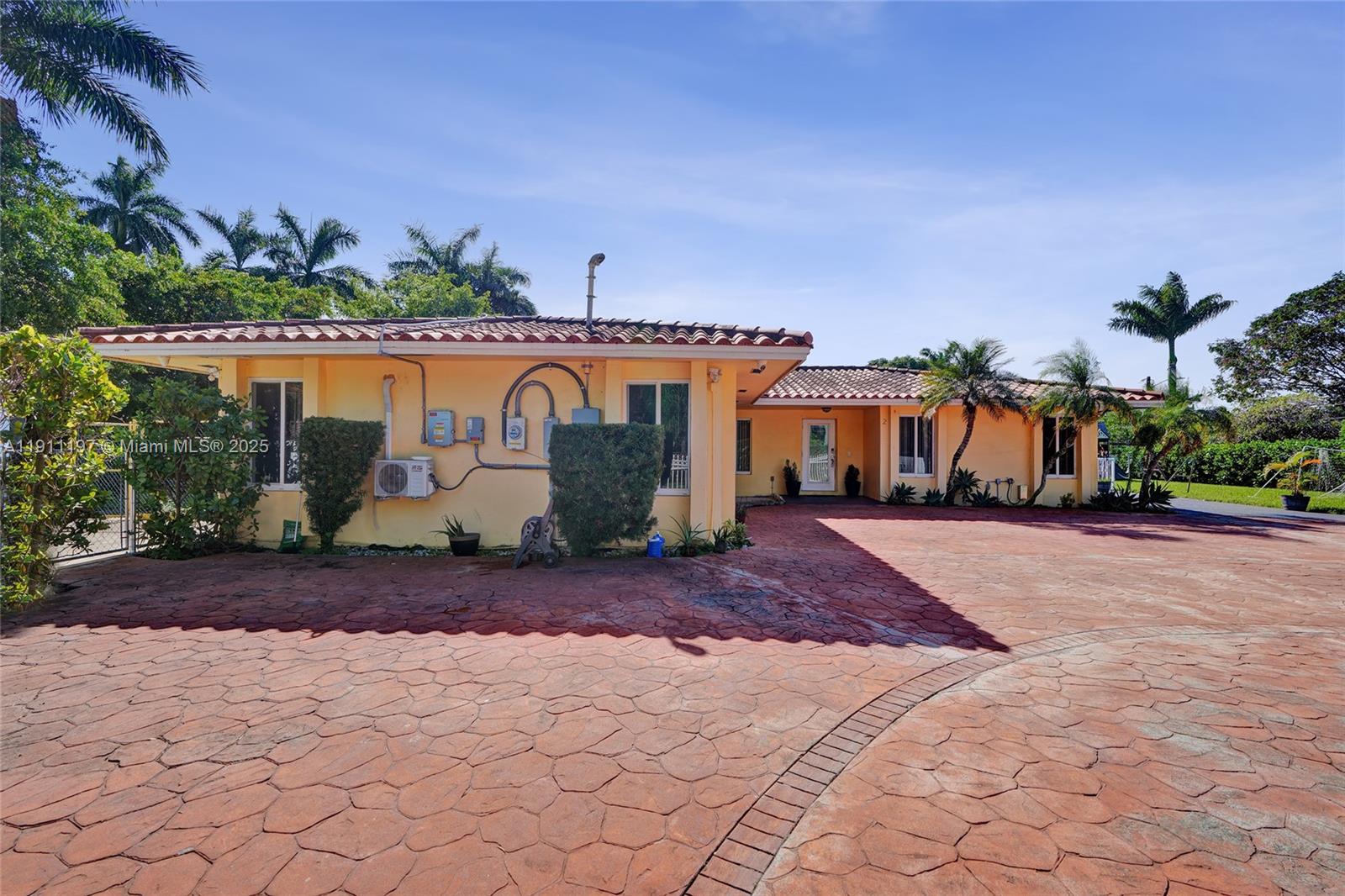 2 Northeast 160th Street Miami, FL 33162 - Photo 47 of 54 a front view of a house with a yard and a garage
