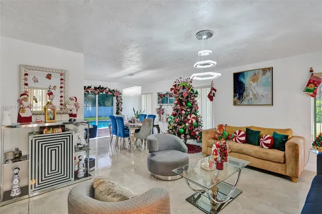 a view of a dining room with furniture and flowers