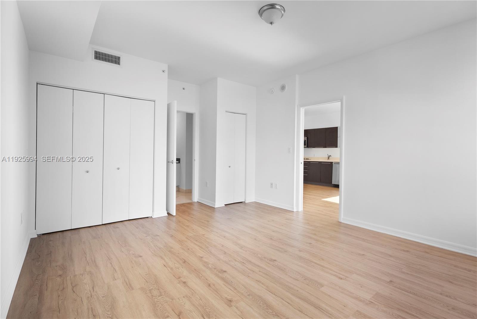 90 Southwest 3rd Street, Unit 1512 Miami, FL 33130 - Photo 11 of 19 a view of an empty room with wooden floor