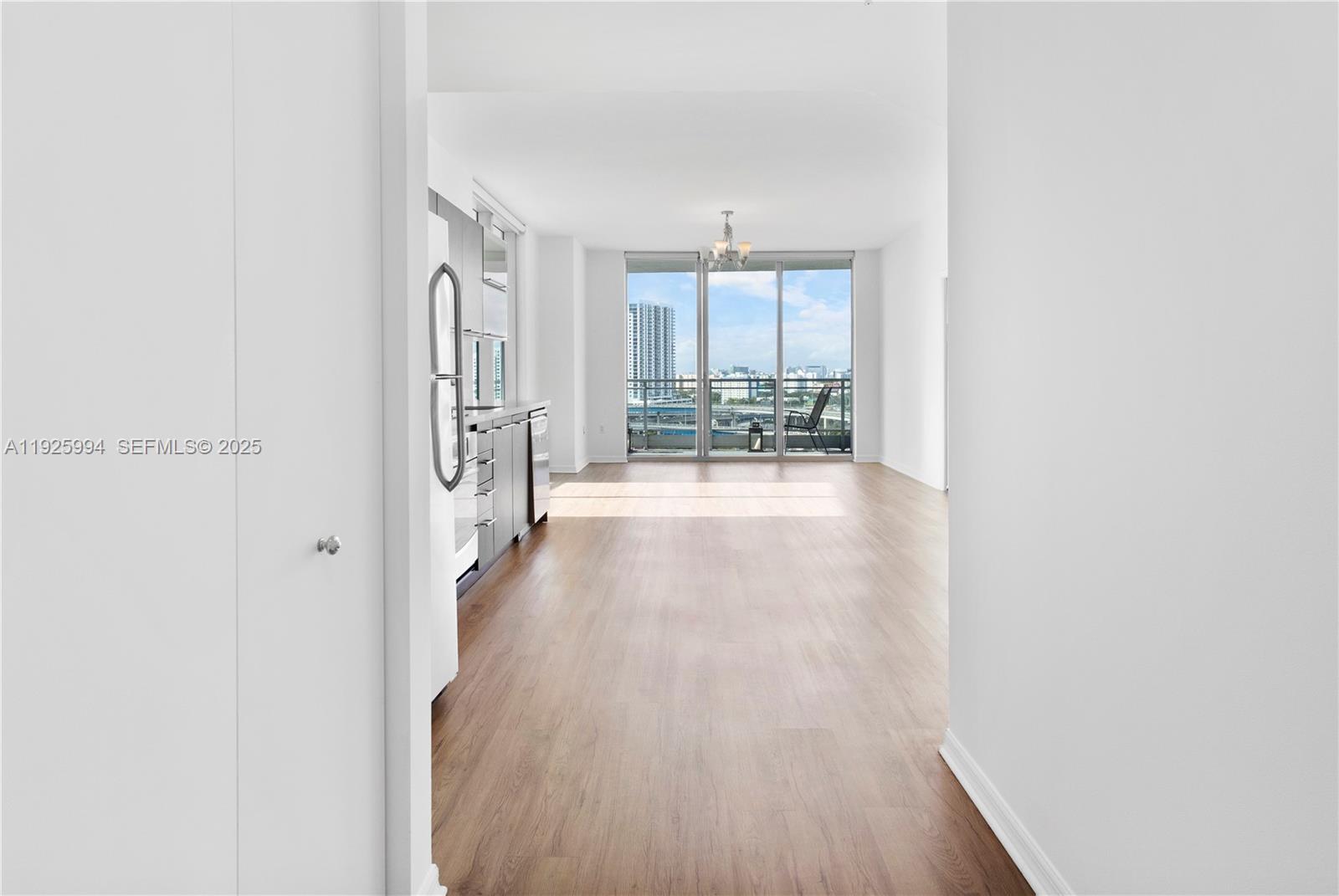 90 Southwest 3rd Street, Unit 1512 Miami, FL 33130 - Photo 18 of 19 a view of a hallway with wooden floor and furniture