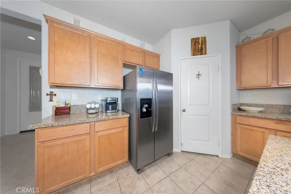 a kitchen with stainless steel appliances granite countertop a refrigerator and a stove top oven