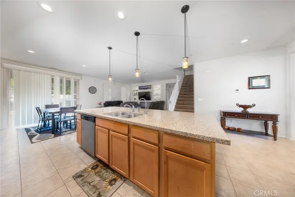 a living room with furniture a dining table and chairs with wooden floor